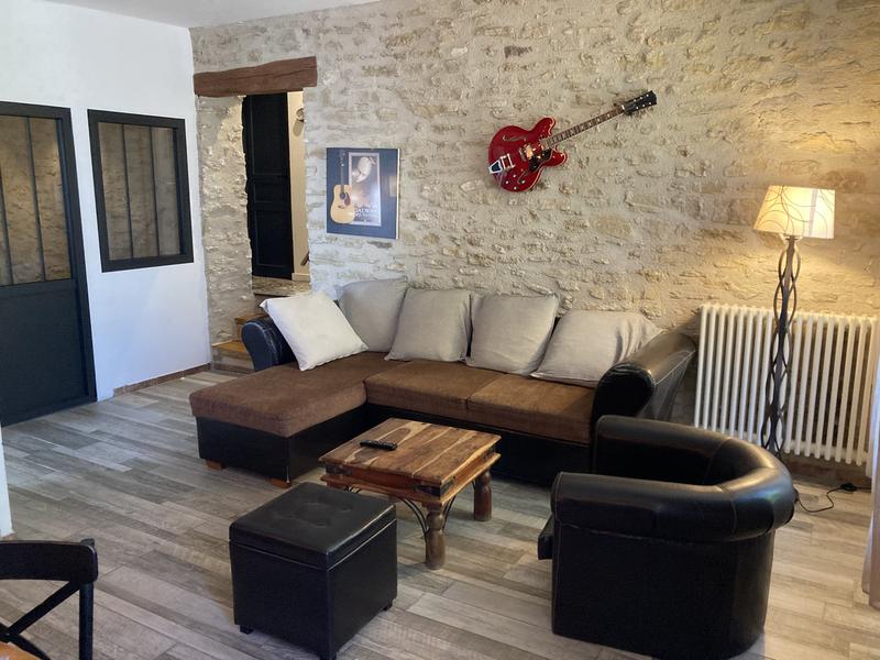 Wohnzimmer mit Steinwand und Ledersofa 